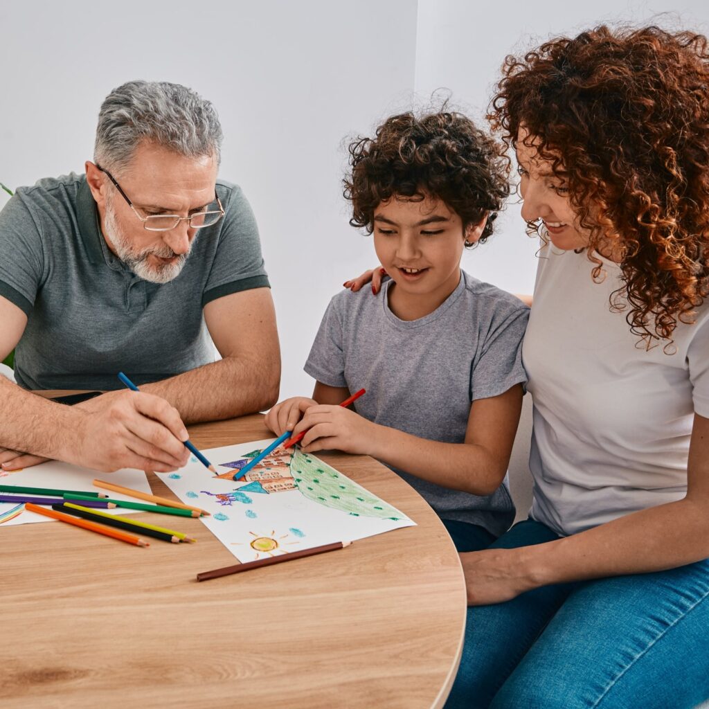 Doctor doing art therapy for child patient while psychologist consultation