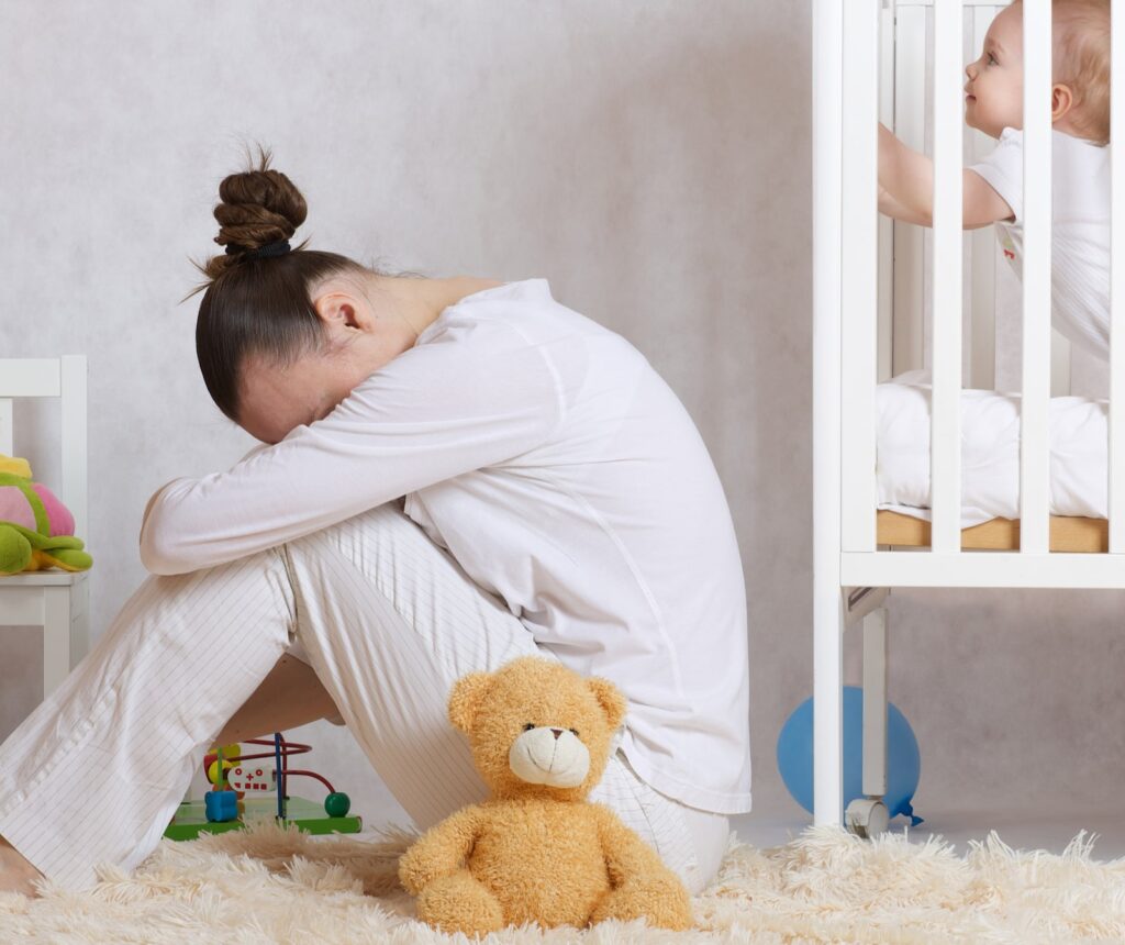 Young mother between 30 and 40 years old is experiencing postnatal depression.